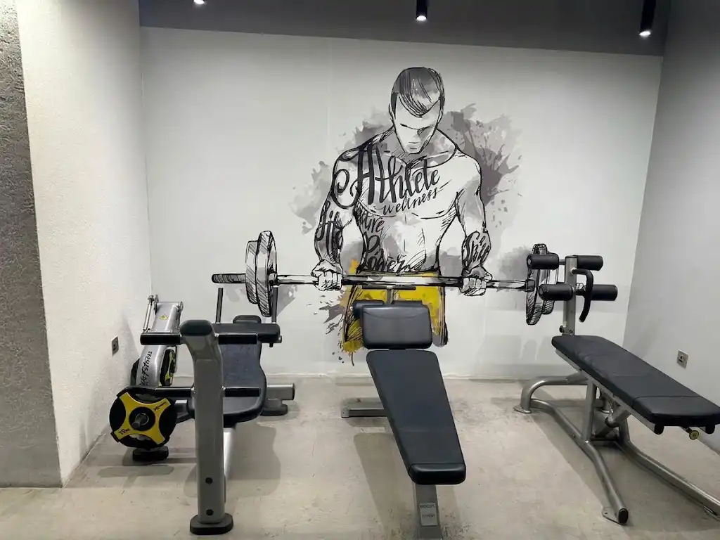 The abdomen area, with ab benches beneath the Athlete Wellness mural